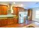 Spacious kitchen with stainless steel appliances and wood flooring at 4634 Mapletree Loop, Wesley Chapel, FL 33544