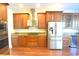 Modern kitchen with stainless steel appliances and wood cabinetry at 4634 Mapletree Loop, Wesley Chapel, FL 33544