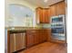 Modern kitchen with stainless steel appliances and wood cabinetry at 4634 Mapletree Loop, Wesley Chapel, FL 33544