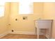 Laundry room with utility sink and tile flooring at 4634 Mapletree Loop, Wesley Chapel, FL 33544