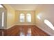 Spacious living room featuring hardwood floors and arched windows at 4634 Mapletree Loop, Wesley Chapel, FL 33544