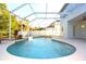 Relaxing kidney-shaped swimming pool with a waterfall feature at 4634 Mapletree Loop, Wesley Chapel, FL 33544