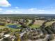 Aerial view of community with golf course and pond at 5493 Legend Hills Ln, Spring Hill, FL 34609