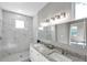 Modern bathroom with double vanity, granite countertop, and marble shower at 5742 Meadowlane St, New Port Richey, FL 34652