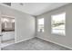 Bright bedroom with carpet, neutral walls, and ensuite bathroom access at 5742 Meadowlane St, New Port Richey, FL 34652