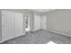 Spacious bedroom with gray carpet and double closets at 5742 Meadowlane St, New Port Richey, FL 34652