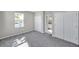 Bedroom with gray carpet, double closets, and en-suite bathroom at 5742 Meadowlane St, New Port Richey, FL 34652