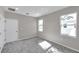 Bedroom with gray carpet, double closets, and windows at 5742 Meadowlane St, New Port Richey, FL 34652
