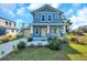 Newly built home featuring a yellow door and blue exterior at 5742 Meadowlane St, New Port Richey, FL 34652