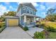 Two-story craftsman home with yellow garage door and front porch at 5742 Meadowlane St, New Port Richey, FL 34652