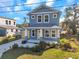 Two-story craftsman home with gray siding and yellow door at 5742 Meadowlane St, New Port Richey, FL 34652