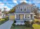 Two-story craftsman home with gray siding and yellow door at 5742 Meadowlane St, New Port Richey, FL 34652