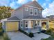 Two-story craftsman home with gray siding and yellow door at 5742 Meadowlane St, New Port Richey, FL 34652
