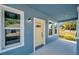 Charming front entry with yellow door and sidelights at 5742 Meadowlane St, New Port Richey, FL 34652
