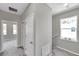 Upstairs hallway with gray carpeting and white doors at 5742 Meadowlane St, New Port Richey, FL 34652