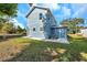 Newly constructed home with blue siding, landscaping, and a spacious backyard at 5742 Meadowlane St, New Port Richey, FL 34652
