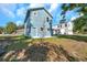 Newly built two-story home with blue siding and a side yard at 5742 Meadowlane St, New Port Richey, FL 34652