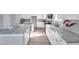 Modern kitchen with granite countertops and white cabinets at 5742 Meadowlane St, New Port Richey, FL 34652