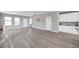 Open living space with gray flooring and white kitchen cabinets at 5742 Meadowlane St, New Port Richey, FL 34652