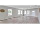 Spacious living room featuring light gray walls and wood-look flooring at 5742 Meadowlane St, New Port Richey, FL 34652