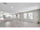 Spacious living room with grey flooring and kitchen view at 5742 Meadowlane St, New Port Richey, FL 34652