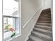 Modern staircase with gray carpeting and white railings at 5742 Meadowlane St, New Port Richey, FL 34652