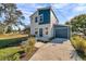 Modern two-story home with blue and white exterior, attached garage, and landscaped front yard at 5746 Meadowlane St, New Port Richey, FL 34652