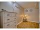 Small bedroom with dresser, lamp, and nautical decor at 5915 Sea Ranch Dr # 704, Hudson, FL 34667