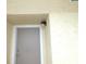 Exterior condo door with light fixture at 5915 Sea Ranch Dr # 704, Hudson, FL 34667