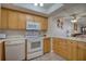 Condo kitchen with light wood cabinets and white appliances at 5915 Sea Ranch Dr # 704, Hudson, FL 34667