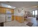 Condo kitchen with light wood cabinets and white appliances at 5915 Sea Ranch Dr # 704, Hudson, FL 34667