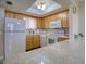 Condo kitchen with light wood cabinets and white appliances at 5915 Sea Ranch Dr # 704, Hudson, FL 34667