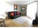 Living room features hardwood floors, a comfy leather couch and access to balcony at 5915 Sea Ranch Dr # 704, Hudson, FL 34667