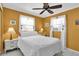 Bedroom with white bedding and ceiling fan at 6650 Hickorywood Ln # 6650, New Port Richey, FL 34653