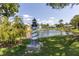 Attractive pondside view with lighthouse sculpture and landscaping at 6650 Hickorywood Ln # 6650, New Port Richey, FL 34653