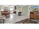 Open concept living and dining area with tile flooring and a view of the kitchen at 6650 Hickorywood Ln # 6650, New Port Richey, FL 34653