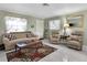 Spacious living room with two recliners, a sofa and a wood coffee table at 6650 Hickorywood Ln # 6650, New Port Richey, FL 34653