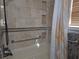 Clean bathroom with tiled shower/tub and grab bars for accessibility at 7129 Beachdale Ct, Port Richey, FL 34668