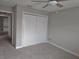 Bedroom with double-door closet and neutral wall paint at 7129 Beachdale Ct, Port Richey, FL 34668