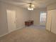 Bedroom with ceiling fan, window blinds, and neutral carpeting at 7129 Beachdale Ct, Port Richey, FL 34668