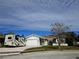Single-story house with a two-car garage and RV parking at 7129 Beachdale Ct, Port Richey, FL 34668