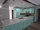 Modern kitchen with light teal cabinets and granite countertops at 7129 Beachdale Ct, Port Richey, FL 34668