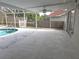 Screened pool area with spacious patio and ceiling fan at 7129 Beachdale Ct, Port Richey, FL 34668