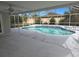 Inviting screened pool with tiled steps and spacious patio at 7129 Beachdale Ct, Port Richey, FL 34668