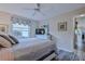 Guest bedroom with TV, dresser, and view to the kitchen at 7290 Rosemont Ln, Spring Hill, FL 34606