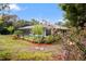 Relaxing screened pool and patio area, lush landscaping at 7368 Royal Oak Dr, Spring Hill, FL 34607