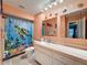 Bathroom with shower/tub combo, vanity, and decorative accents at 8015 Pequena Dr, Port Richey, FL 34668