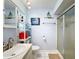 Bathroom has shower, toilet and vanity with storage at 8015 Pequena Dr, Port Richey, FL 34668
