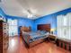 Bright bedroom with wood bed frame, dresser, and ceiling fan at 8015 Pequena Dr, Port Richey, FL 34668