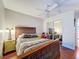 Bedroom with wood bed frame, mirror closet doors, and ceiling fan at 8015 Pequena Dr, Port Richey, FL 34668